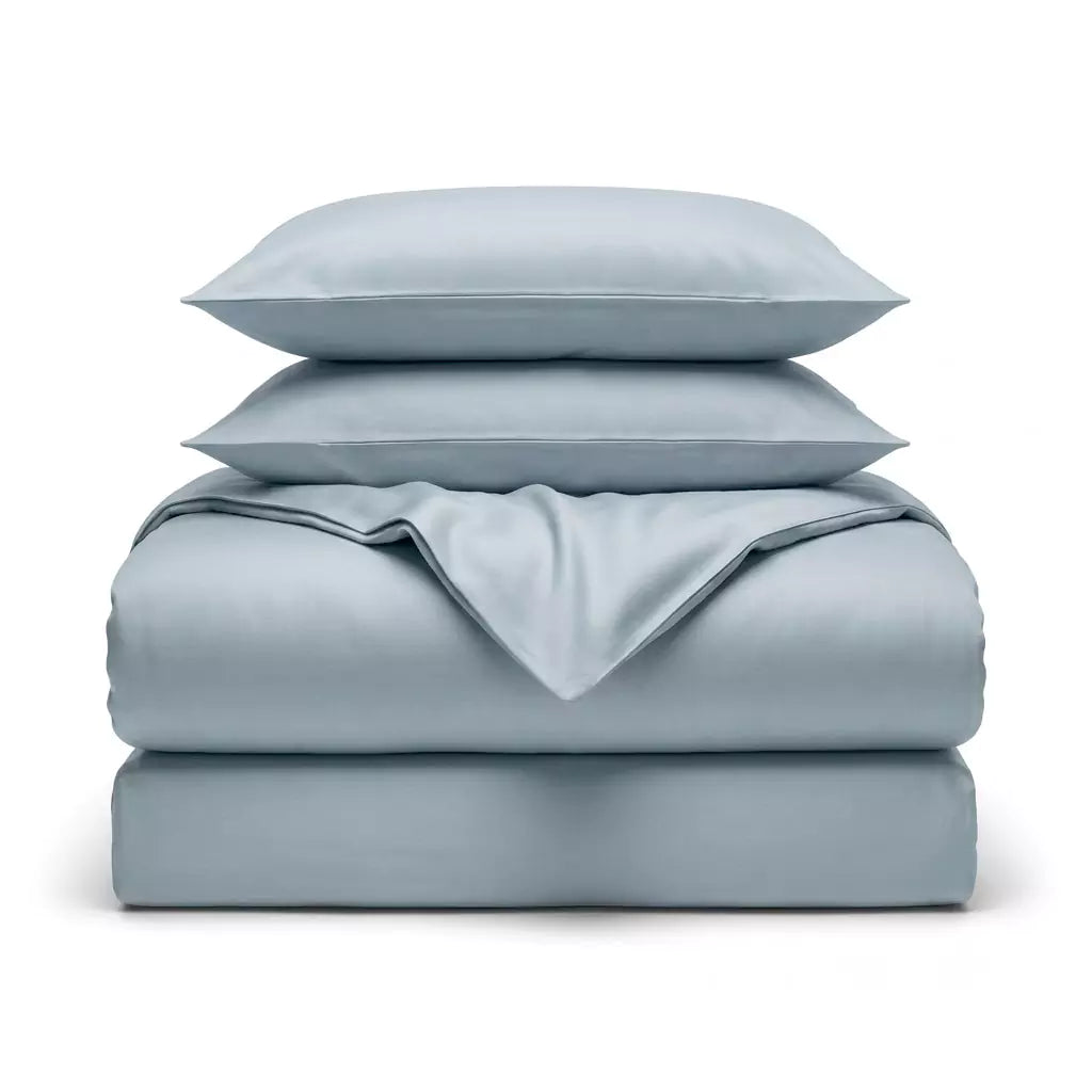 Folded 4-piece TENCEL™ Lyocell bedding set including duvet cover, fitted sheet and pillowcases Misty Blue